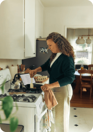 Person cooking in a sunlit kitchen
